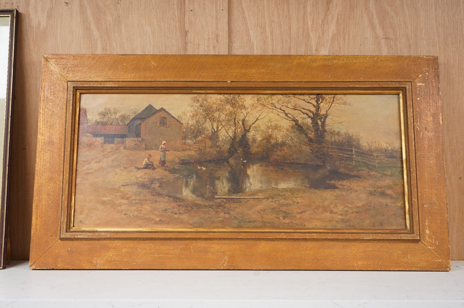 L. Watts, 19th/20th century, oil on canvas, rural scene with figures and a pond, 24 x 56cm. Condition - fair/good